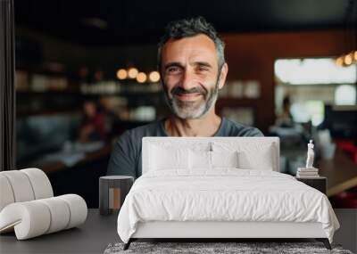 Smiling portrait of a happy middle aged caucasian small busness and restaurant owner in his restaurant Wall mural