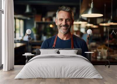 Smiling portrait of a happy middle aged caucasian small busness and restaurant owner in his restaurant Wall mural