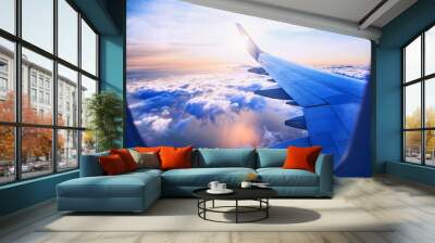 flying and traveling, view from airplane window on the wing on sunset time Wall mural