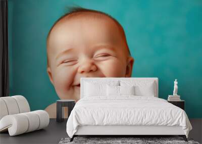 A baby is smiling and laughing, with its mouth wide open Wall mural