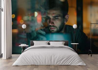 A man is sitting at a table with a laptop and a cup of coffee Wall mural