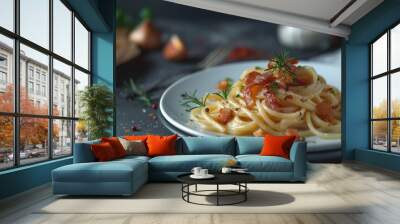 A plate of spaghetti with bacon and herbs on top Wall mural