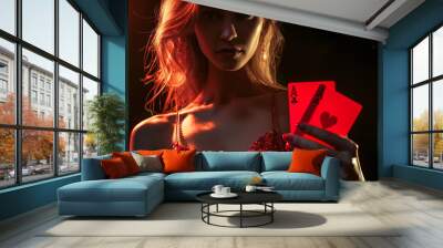 A woman is holding two red playing cards in her hand Wall mural