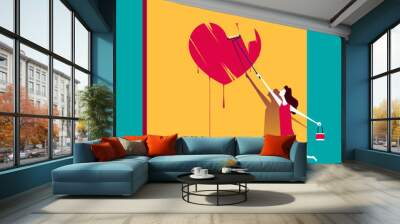 Young woman paints a heart on the wall Wall mural