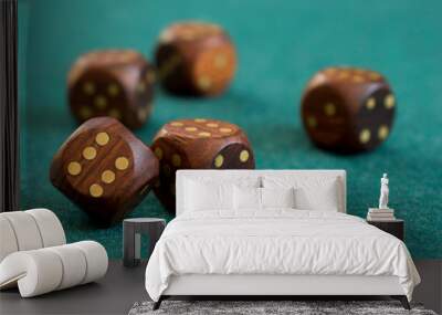 Wooden dice on green cloth dark background casino chance gamble Wall mural