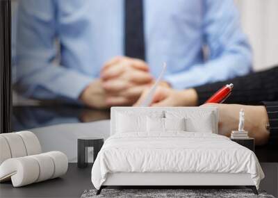 woman is signing contract with business man in background Wall mural