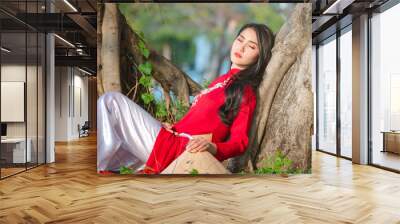 Portrait of Vietnamese girl traditional red dress,Beautiful young asian woman wearing Vietnam Wall mural