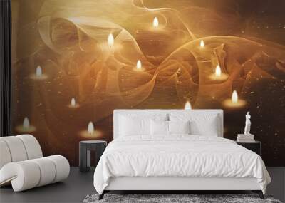 A group of lit candles glowing against a soft, warm, swirling background. Wall mural