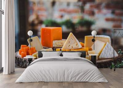 Cheese Assortment of different cheeses on a wooden board. Wall mural