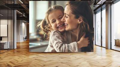 Happy family having fun time at home, smiling mom hugging and having fun with her little girl on blurred modern home background with copy space. Wall mural