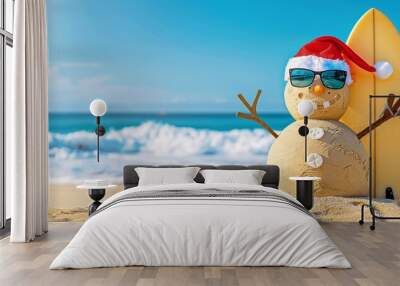 Smiling Santa sandy snowman in red santa hat and stylish sunglasses smiling on the sea beach with copy space, concept of winter holiday, Merry Christmas, happy summer time. Wall mural