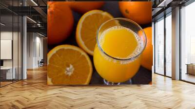 Natural orange juice in a glass on top of a wooden table Wall mural