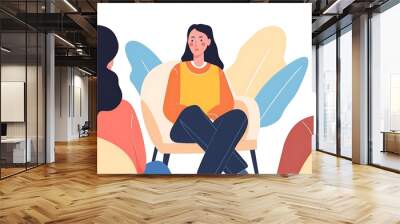 A group discussion with a woman seated in a chair, engaging with two others. Wall mural