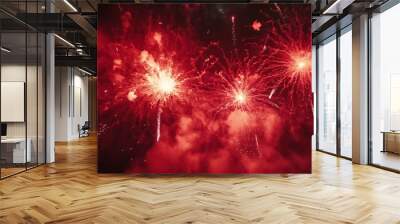 Vibrant red fireworks bursting in the night sky, creating a festive atmosphere. Wall mural