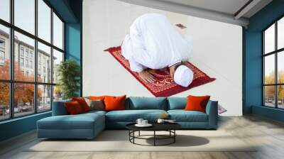 A portrait of an asian muslim man pray at mosque, the pray name is sholat, sujud movement on sholat Wall mural