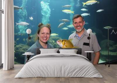 Aquarium Curators Curators in front of a large tank one feeding Wall mural