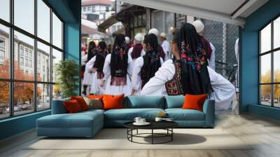 International parade in the streets of Skopje, Macedonia with traditional costume folk dress ready to dance in the festival. Group of folklore people Wall mural