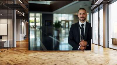 A smiling security guard at work against the background of a business center or office with a place to copy. Wall mural