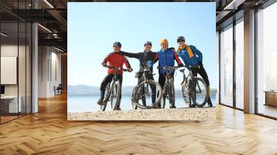 group of cyclists on shore of a mountain lake. team outdoors. mountain bike Wall mural