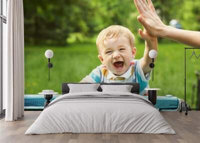 outdoor portrait of a boy on green background. happy child on walking in summer park. Wall mural