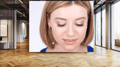 Woman portrait closeup. The gaze is directed downward Wall mural