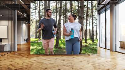 An inspiring scene unfolds as a beautiful, overweight female embarks on a jog in the park with her dedicated partner, embracing their journey to better health.	  Wall mural