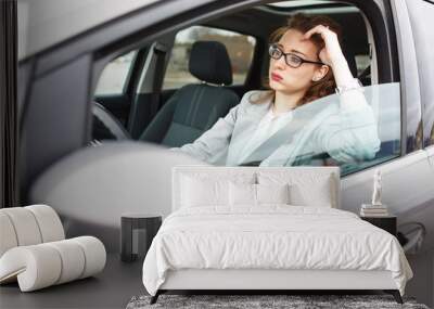 Attractive red hair businesswoman stuck in a traffic jam.Running late to work. Wall mural