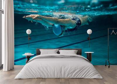 Female swimmer at the swimming pool.Underwater photo. Wall mural