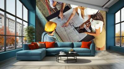 Group of architects and engineers discuss about construction blueprint.High angle view. Wall mural