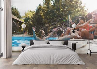 Group of friends making fun and play in the swimming pool.They smiling and joying in hot summer day. Wall mural