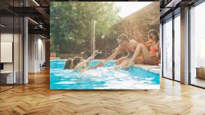 Group of friends making fun and play in the swimming poolThey smiling and joying in hot summer day. Wall mural