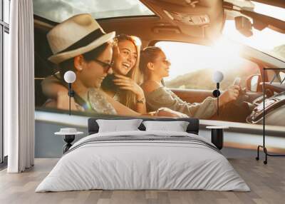 Three best female friends travel together. They drive a car and having fun. Summer adventure.	 Wall mural