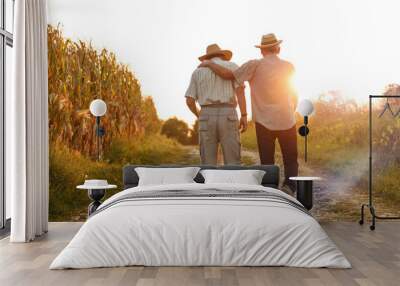 Two old friends.Two senior friends walks trough corn field on sunset.	
 Wall mural