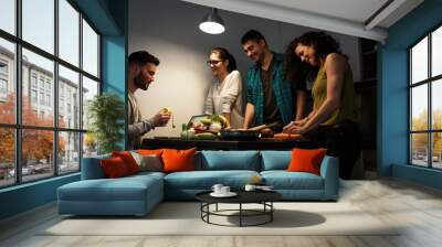 Young group of friends preparing vegetable meal and making fun. Wall mural