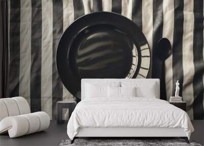 black and white striped background with a dark plate and spoon Wall mural