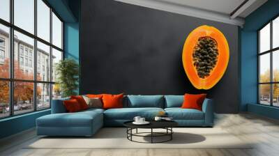 half of a ripe orange papaya fruit on a black background Wall mural