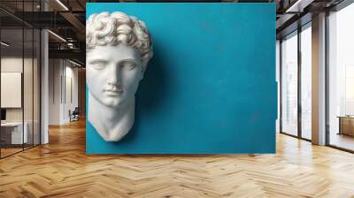 Marble statue head with curly hair against turquoise background Wall mural