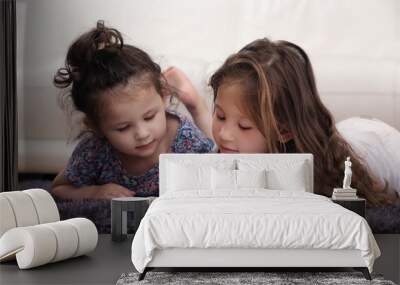 Two Little Sisters Reading Bible on Carpet Wall mural