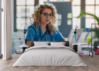 A doctor woman in a blue scrubs is typing on a laptop computer. She is wearing glasses and has a stethoscope around her neck. The scene suggests that she is a medical professional working on a compute Wall mural