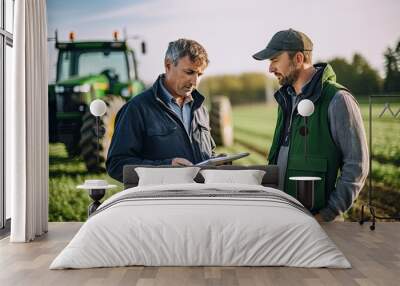 Agricultural engineer utilizing tablet technology while working in a field Wall mural