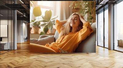 Happy woman relaxing on the sofa at home - Smiling girl enjoying day off lying on the couch, Healthy life style, good vibes people and new home concept Wall mural