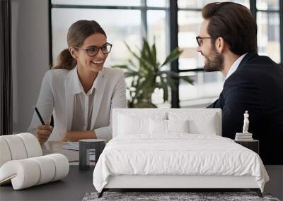 In an office environment, a man and woman are seated at a table,in a business meeting or discussion Wall mural