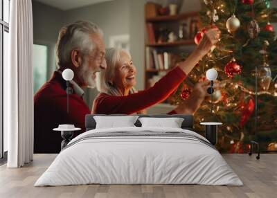 Mature senior happy couple decorating Christmas tree at home,celebrating winter holidays together Wall mural