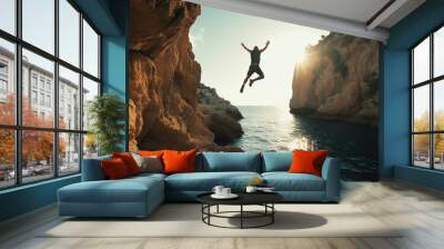 Photo of a person cliff jumping into the deep blue ocean waters, travel, summer, holiday concept Wall mural