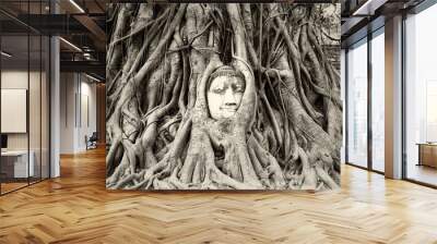 Buddha head in tree roots in Wat Mahathat, Ayutthaya, Thailand  Wall mural