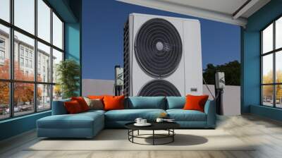 Air conditioning (HVAC) on the roof of an industrial building with blue sky and clouds.	 Wall mural