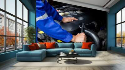 Car mechanic working on car engine, car maintenance concept. Wall mural