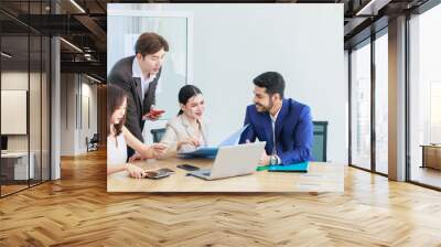 Asian Indian multinational professional successful bearded male businessman explaining discussing brainstorming with female businesswomen colleagues in formal business suit in office meeting room Wall mural