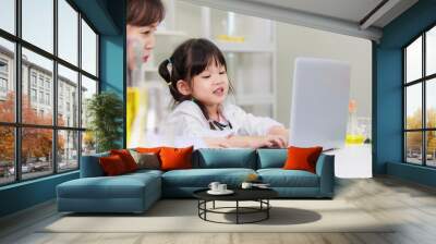 Asian woman teacher and little children girl reading laptop computer for data learning science at chemical laboratory study room. Education research and development concept learning for kids. Wall mural