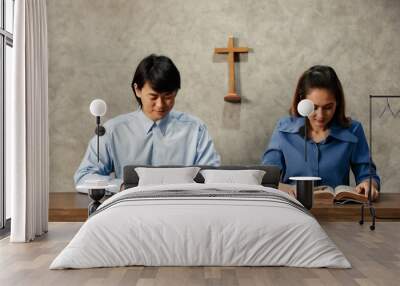 Asian Women and men, The faithful and Christian are reading the Bible to pray to Jesus in the crucified church. Concept believe faith prayer. Wall mural